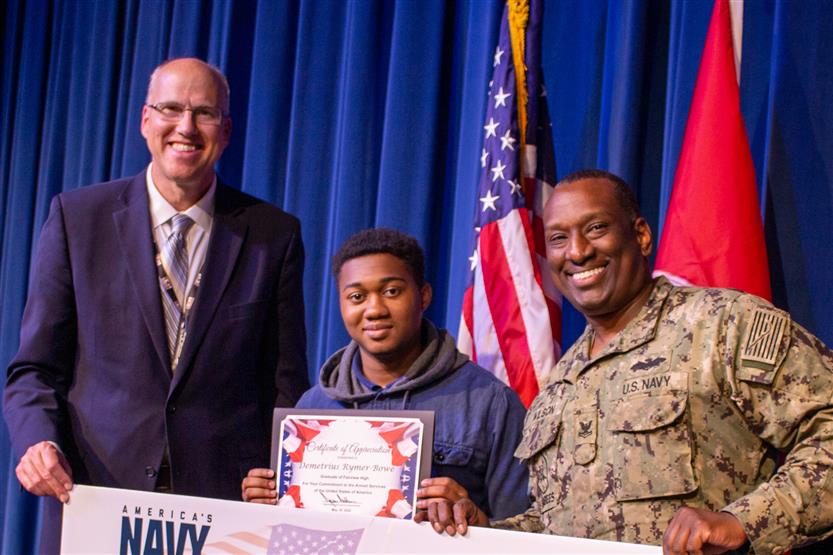 A student is honored for serving in the US Armed Forces after high school